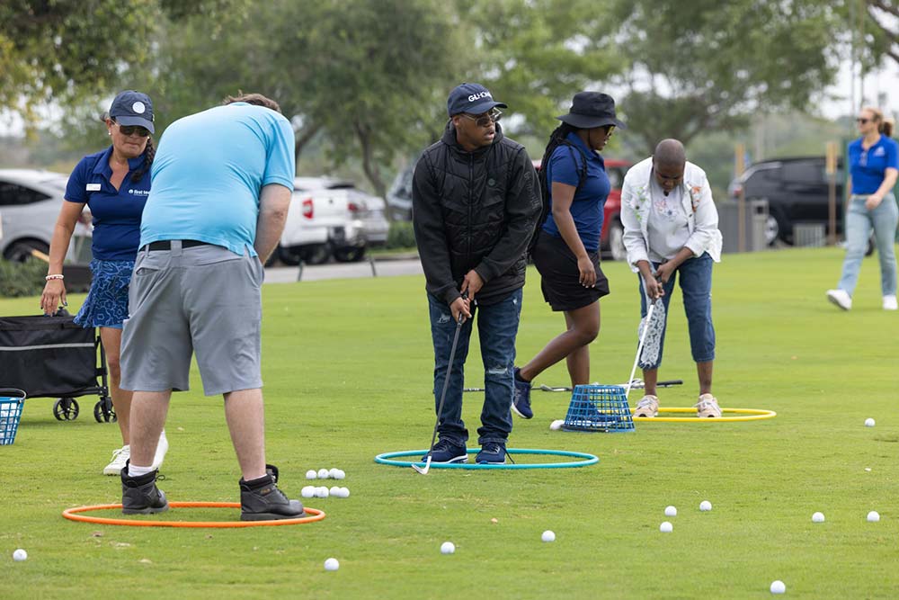 GL Homes golfs with Legal Aid Society member. 