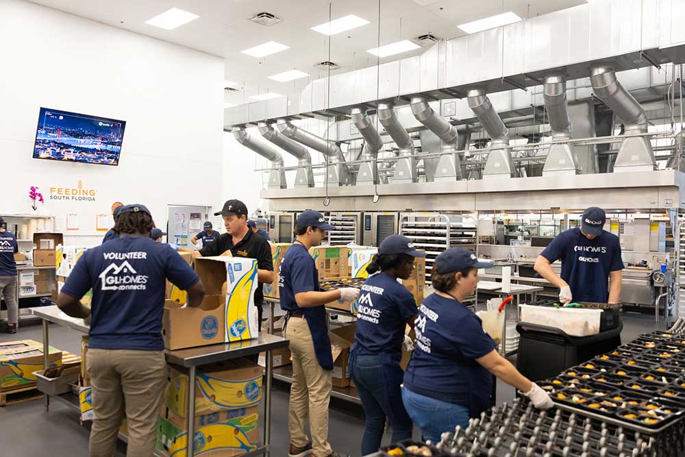 GL Homes volunteers and helps Feeding South Florida prepare food for seniors.