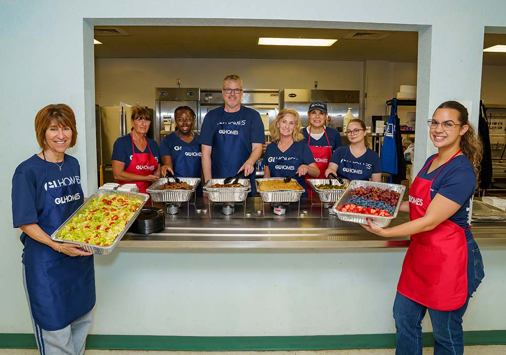 The GL Homes team at the Philip D. Lewis Center helping feed the homeless.