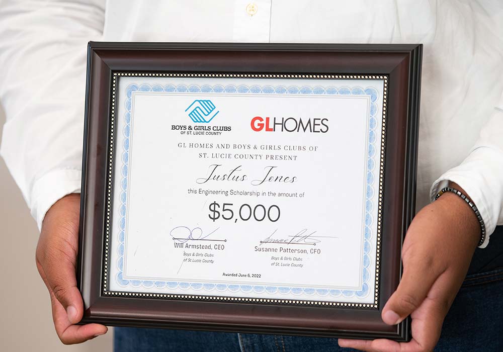 Justus Jones with his scholarship from GL Homes.