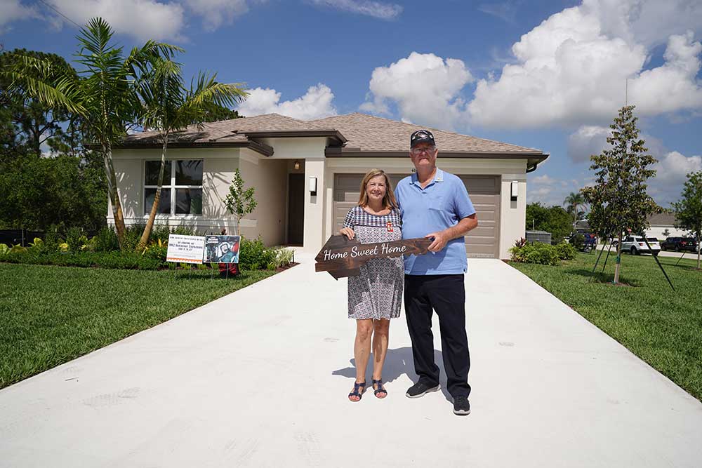 Kathi and Gene Sandburg, a Gold Star family, in front of the home built by GL Homes.