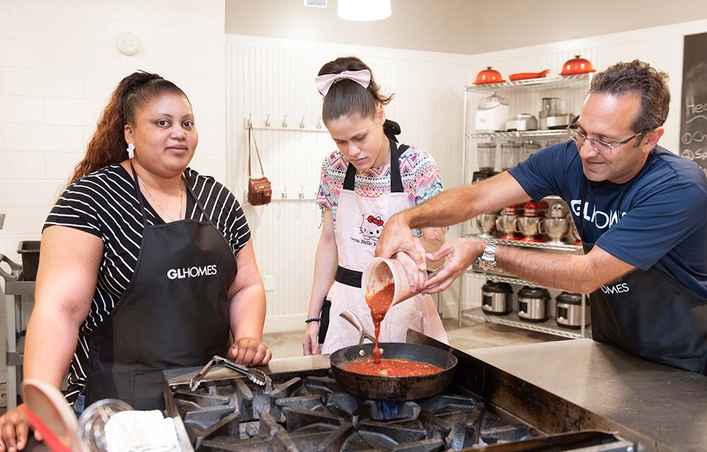 GL Homes hosts and helps Legal Aid Society intellectually disabled adults in cooking class.