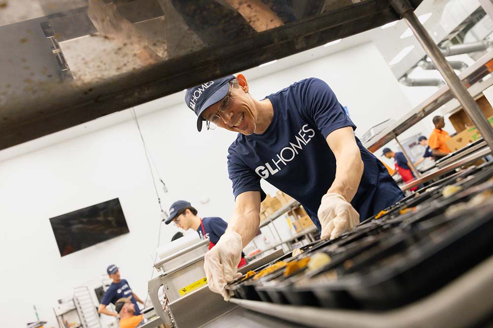 Jeremy Carter prepares food as a GL Homes volunteer. 
